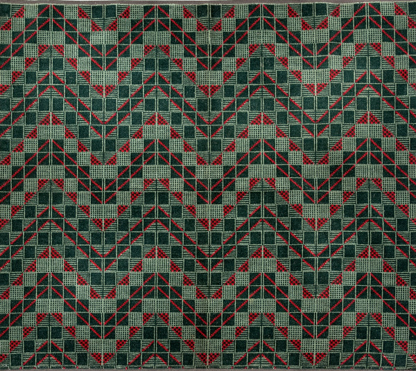  Geometric chevron design in red and two shades of green, consisting of a grid of squares with diagonal lines